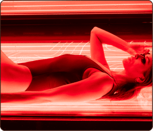 Woman relaxing in a red light therapy bed at The Tanning Shop UK – red light therapy treatment