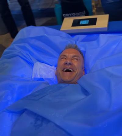 Cryotherapy blog - man laughing in Zerobody dry float cryotherapy bed with blue light treatment at The Tanning Shop UK