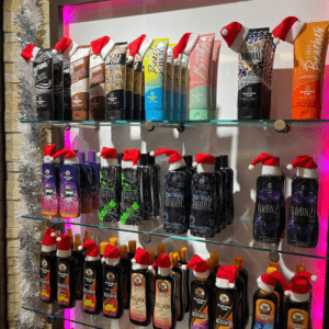 Christmas tanning lotions display shelf with Santa hats at The Tanning Shop UK