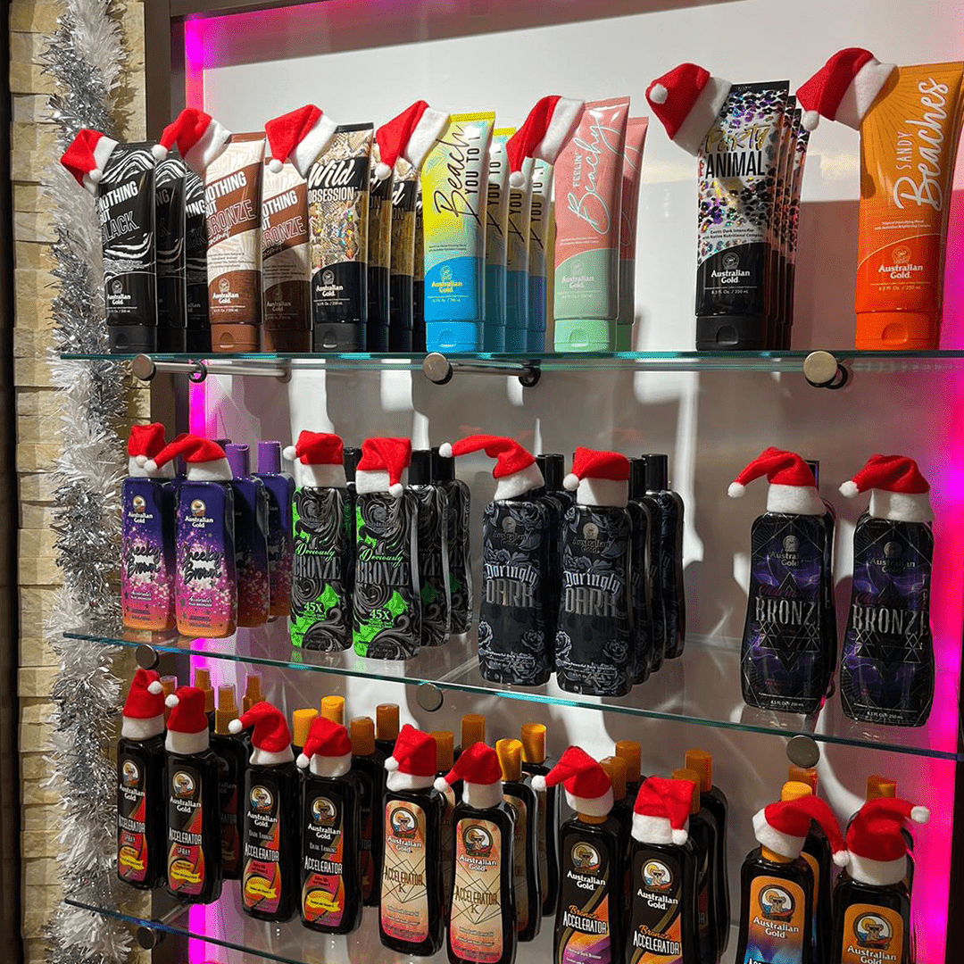 Christmas tanning lotions display shelf with Santa hats at The Tanning Shop UK