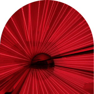 Close-up of a red light therapy bed canopy showing rows of radiating red LED lights in a semicircular arrangement, for The Tanning Shop Red Light Therapy in London page