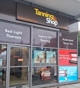 The Tanning Shop Hereford storefront with signage showing Red Light Therapy, Luxury UV Tanning and Automated Spray Tan services