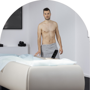 Man in towel preparing for a whole-body cryotherapy session on a Zerobody dry floatation bed at The Tanning Shop