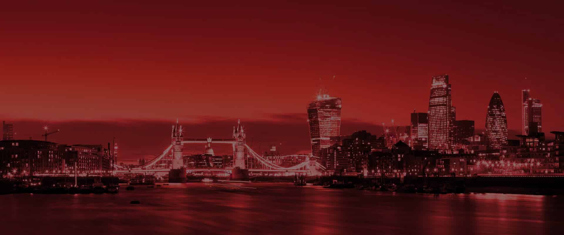 London skyline at night featuring Tower Bridge, representing The Tanning Shop's red light therapy services across London