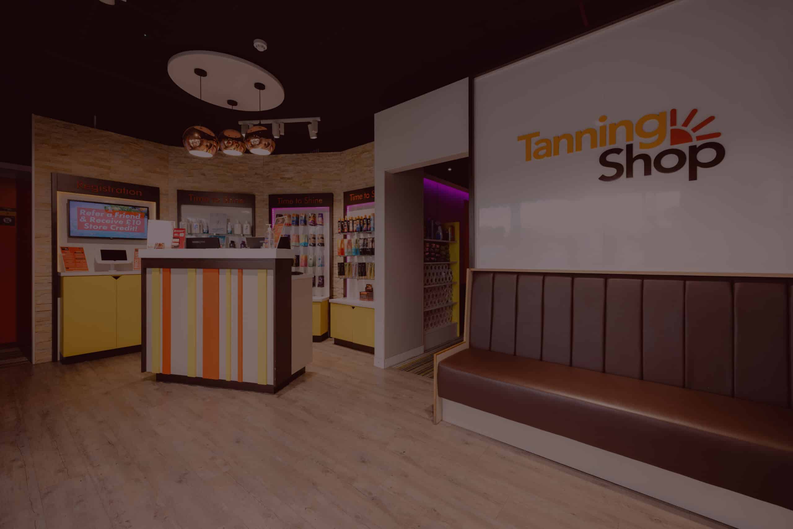 The Tanning Shop Salon Interior Reception Interior of a Tanning Shop salon showing the reception desk, tanning product displays, and welcoming waiting area at a UK location